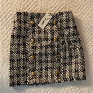Tweed mini skirt with gold buttons.